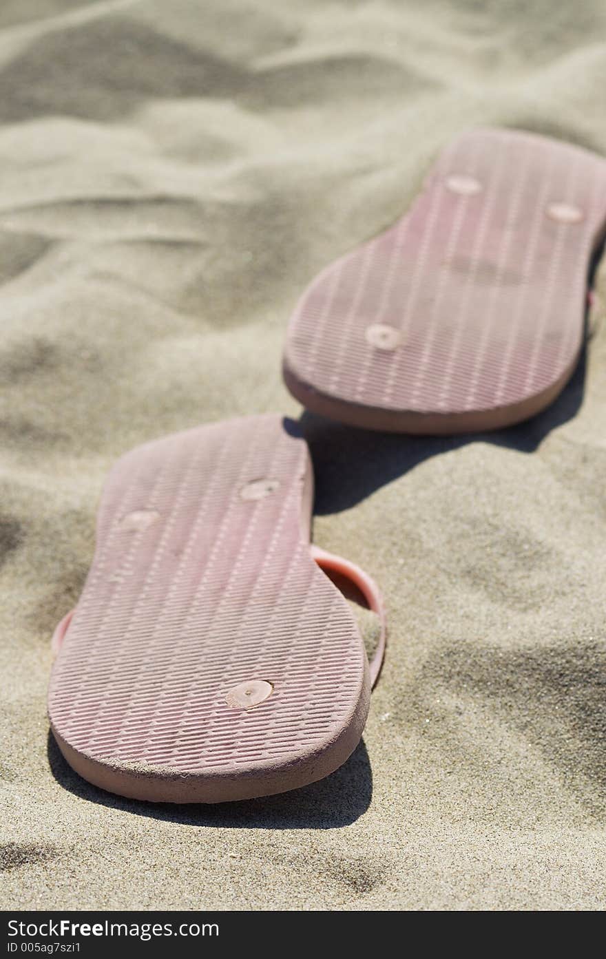 Close up on slippers on beach sand