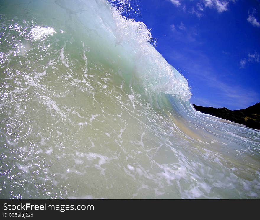 A wave curling towards the shore in Hawaii. A wave curling towards the shore in Hawaii.