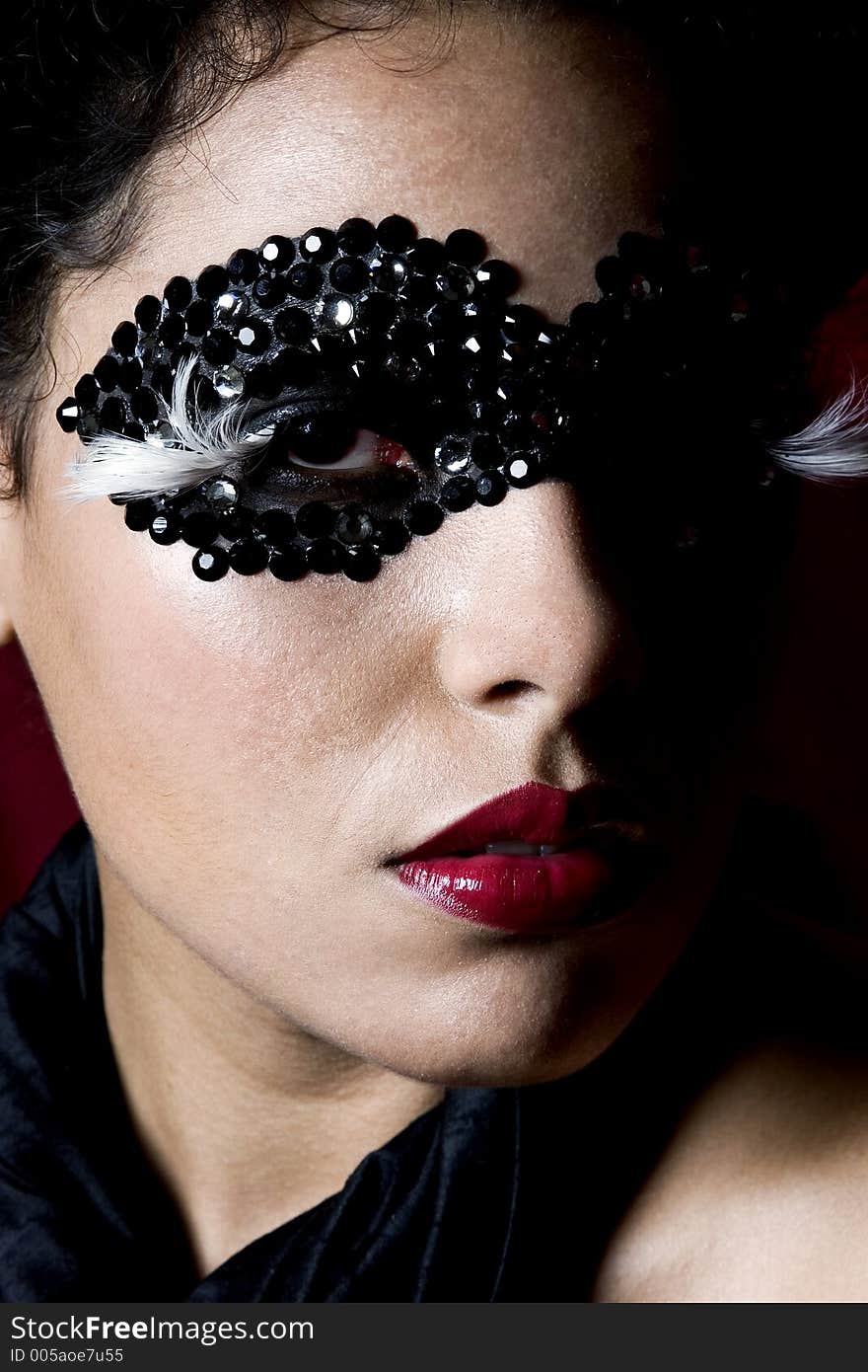 Attractive Young Woman Wearing A Black Gem Mask