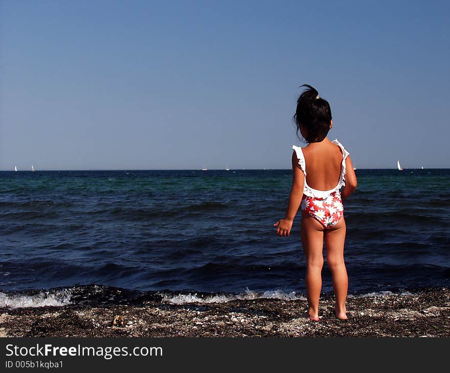 Child playing a summer day at the beach in denmark. Child playing a summer day at the beach in denmark