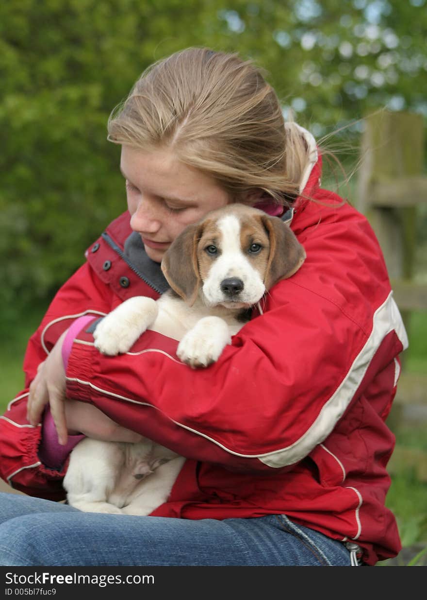 Teenager cuddles her adorable 8 week old puppy. Teenager cuddles her adorable 8 week old puppy