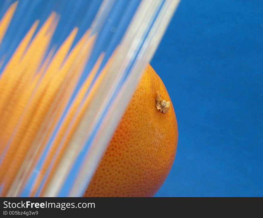 Orange and glass on blue background