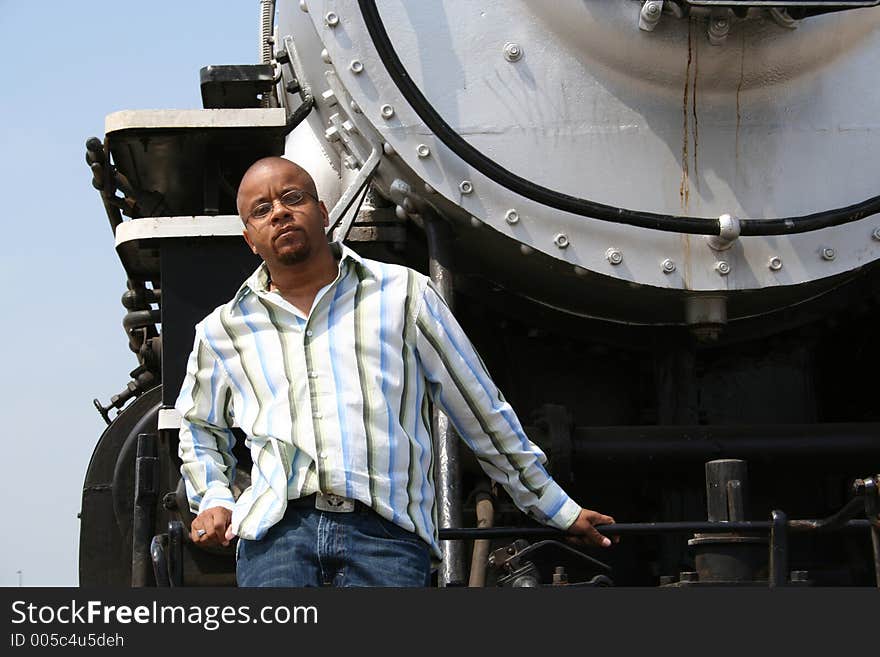 Young man posing on old train locomotive. Young man posing on old train locomotive