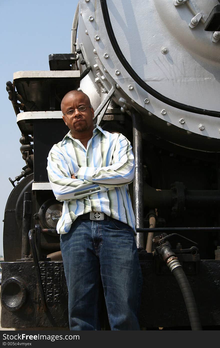 Young man posing on old train locomotive. Young man posing on old train locomotive