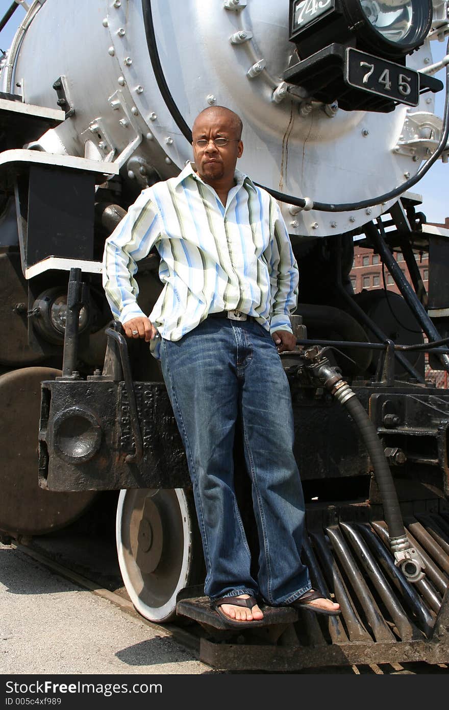 Young man posing on old train locomotive. Young man posing on old train locomotive