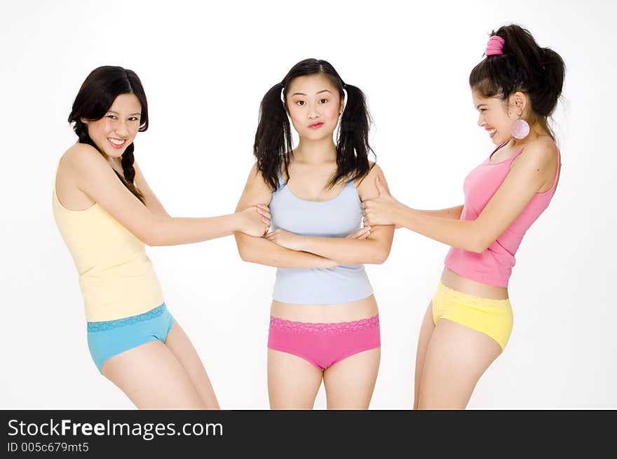 Two pretty asian women fighting over a friend. Two pretty asian women fighting over a friend