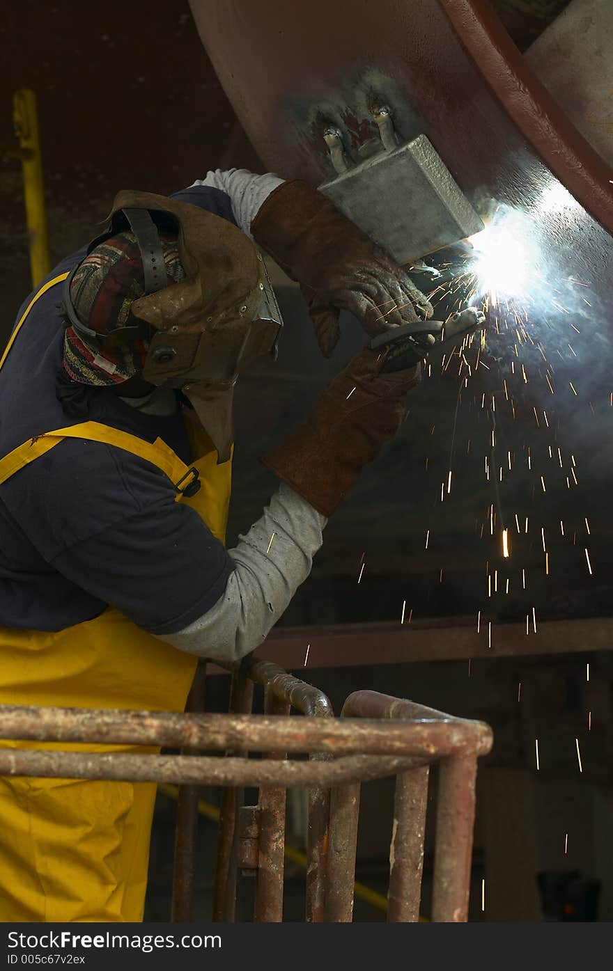 Welder working out of manlift. Welder working out of manlift