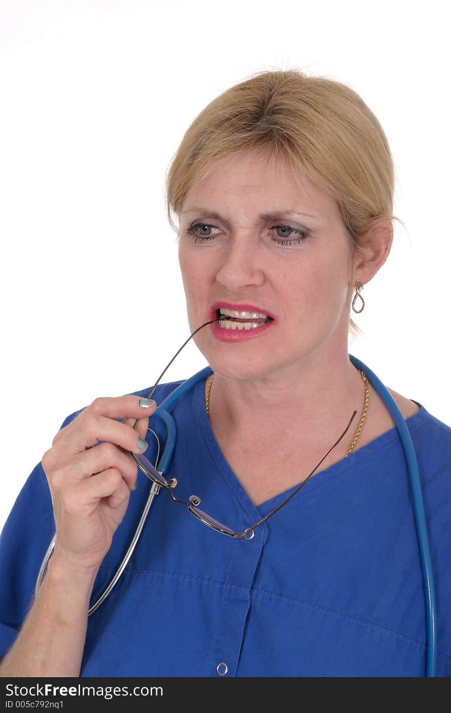 Photo of nurse or doctor with stethoscope and glasses in mouth thinking, in thought. Photo of nurse or doctor with stethoscope and glasses in mouth thinking, in thought