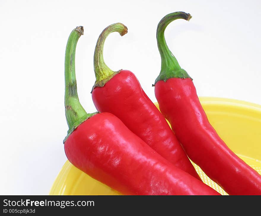 Red peppers on the yellow plate