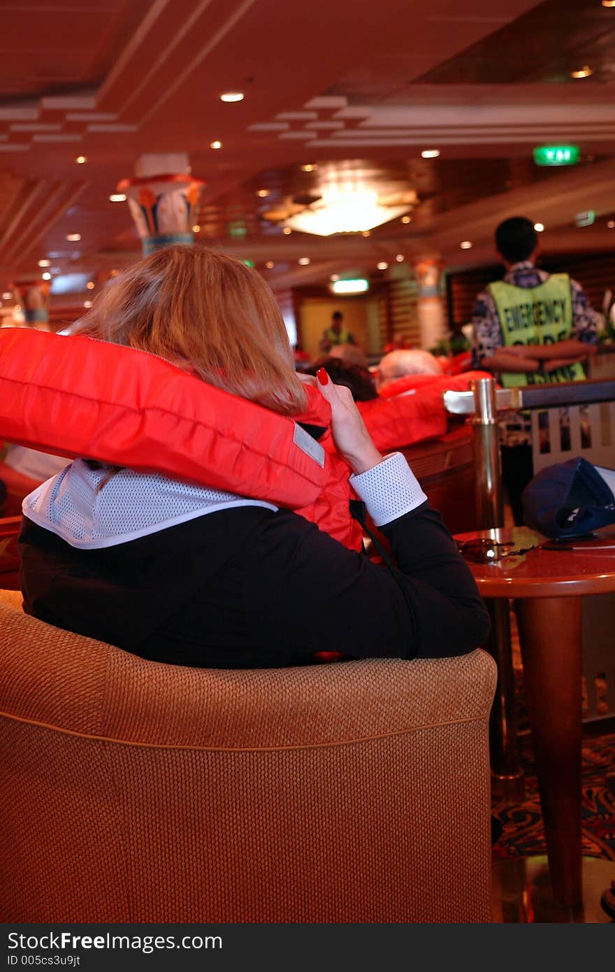 Woman with lifevest during safety drill on cruiseship