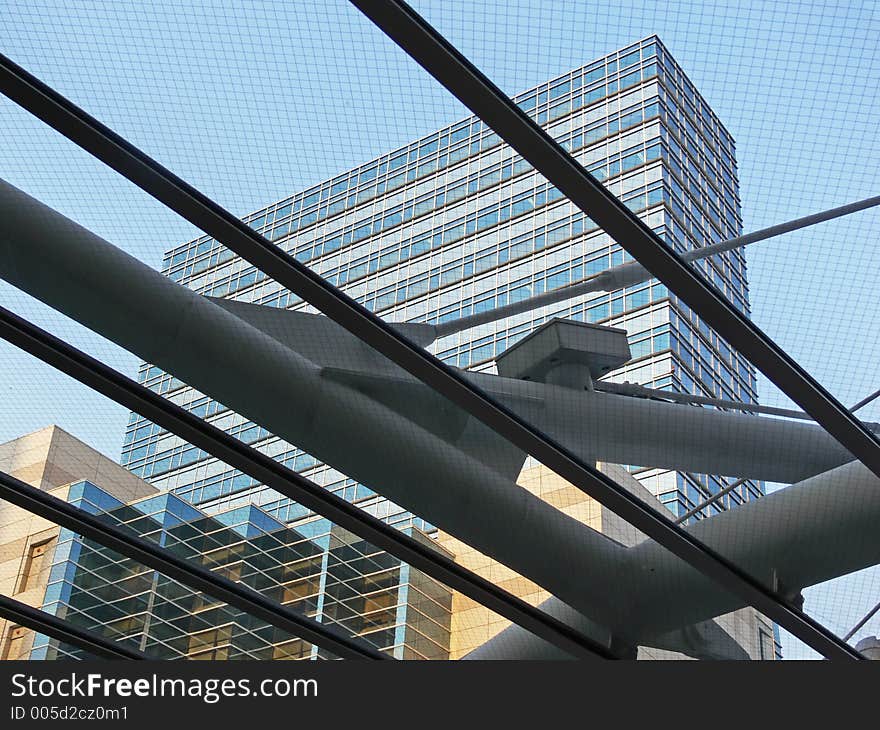 View through a glass roof towards a tall hotel buildg. View through a glass roof towards a tall hotel buildg