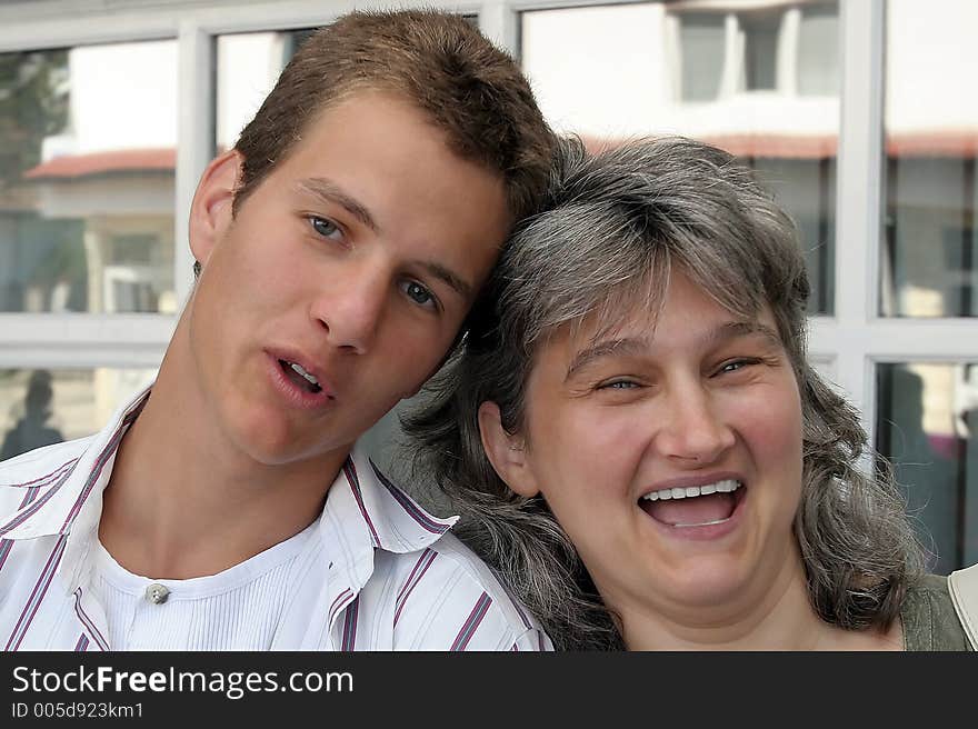 Mother and son laughing happily. Mother and son laughing happily