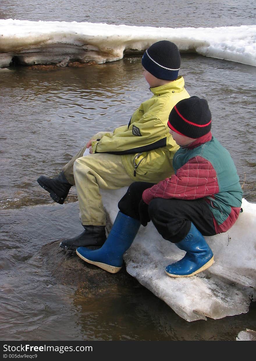 Boys are floating on the ice floe. Boys are floating on the ice floe