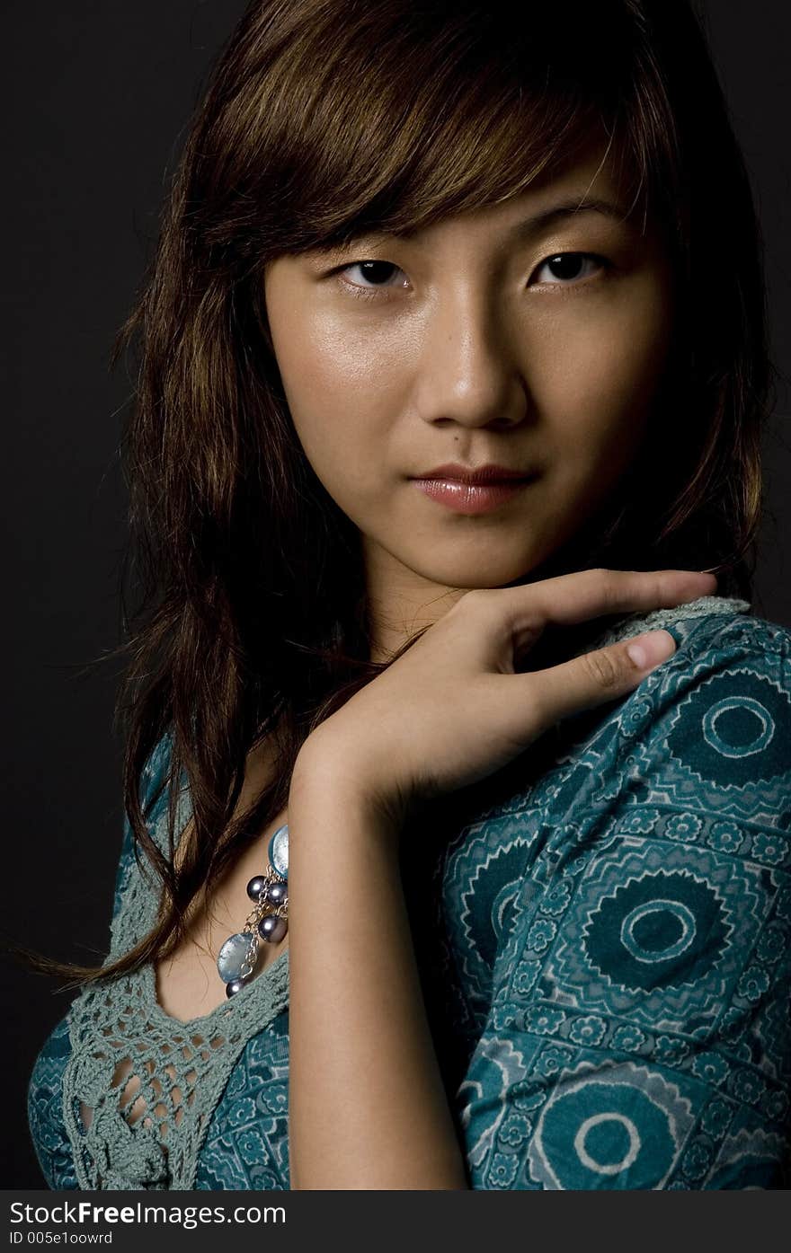 An attractive young asian woman on black background. An attractive young asian woman on black background