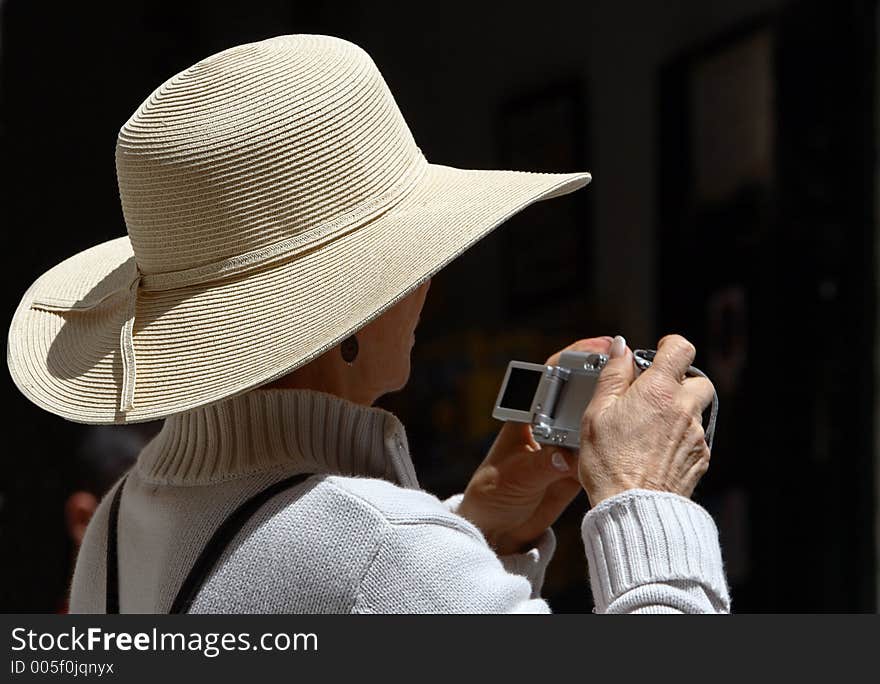 Woman wearing hat with digital camera. Woman wearing hat with digital camera