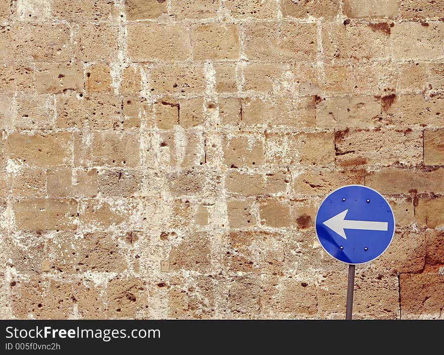 Road sign with the brick wall in the background. Road sign with the brick wall in the background