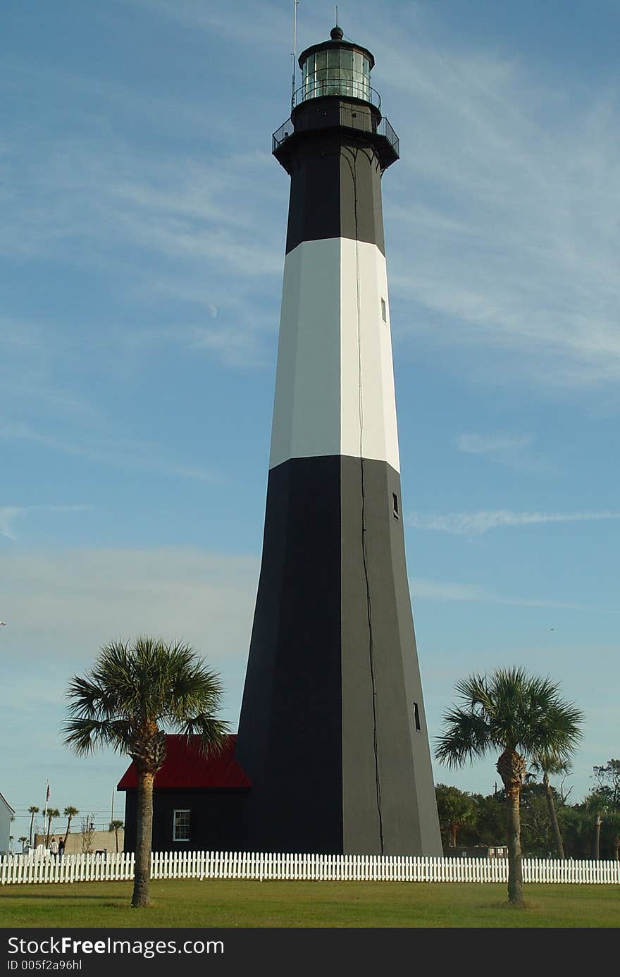 View of an old lighthouse and palm trees.