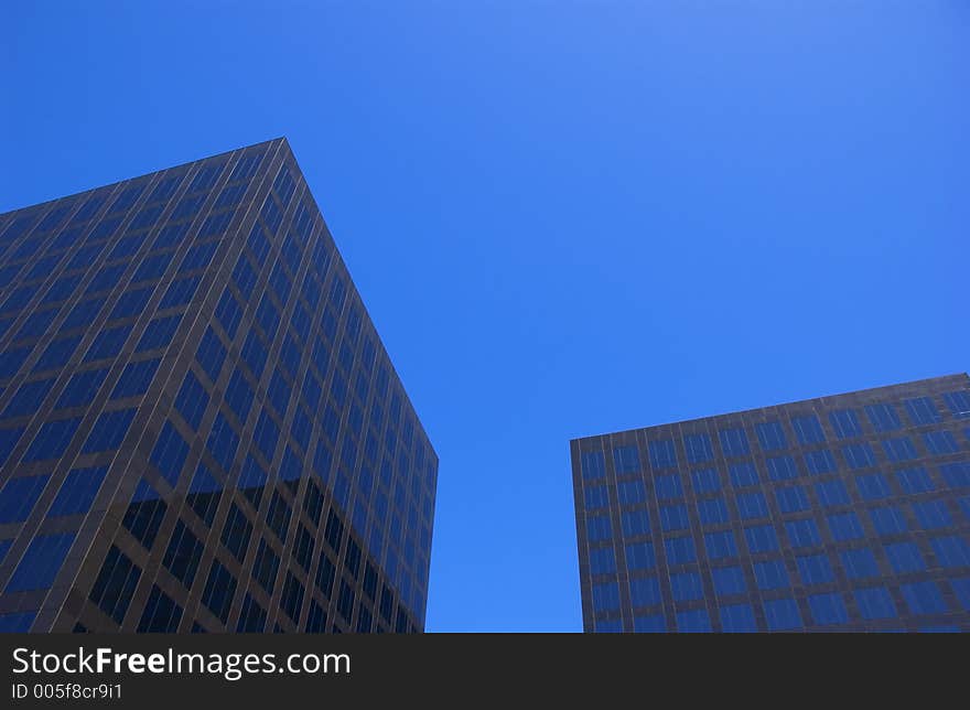 Two corporate buildings and blue sky