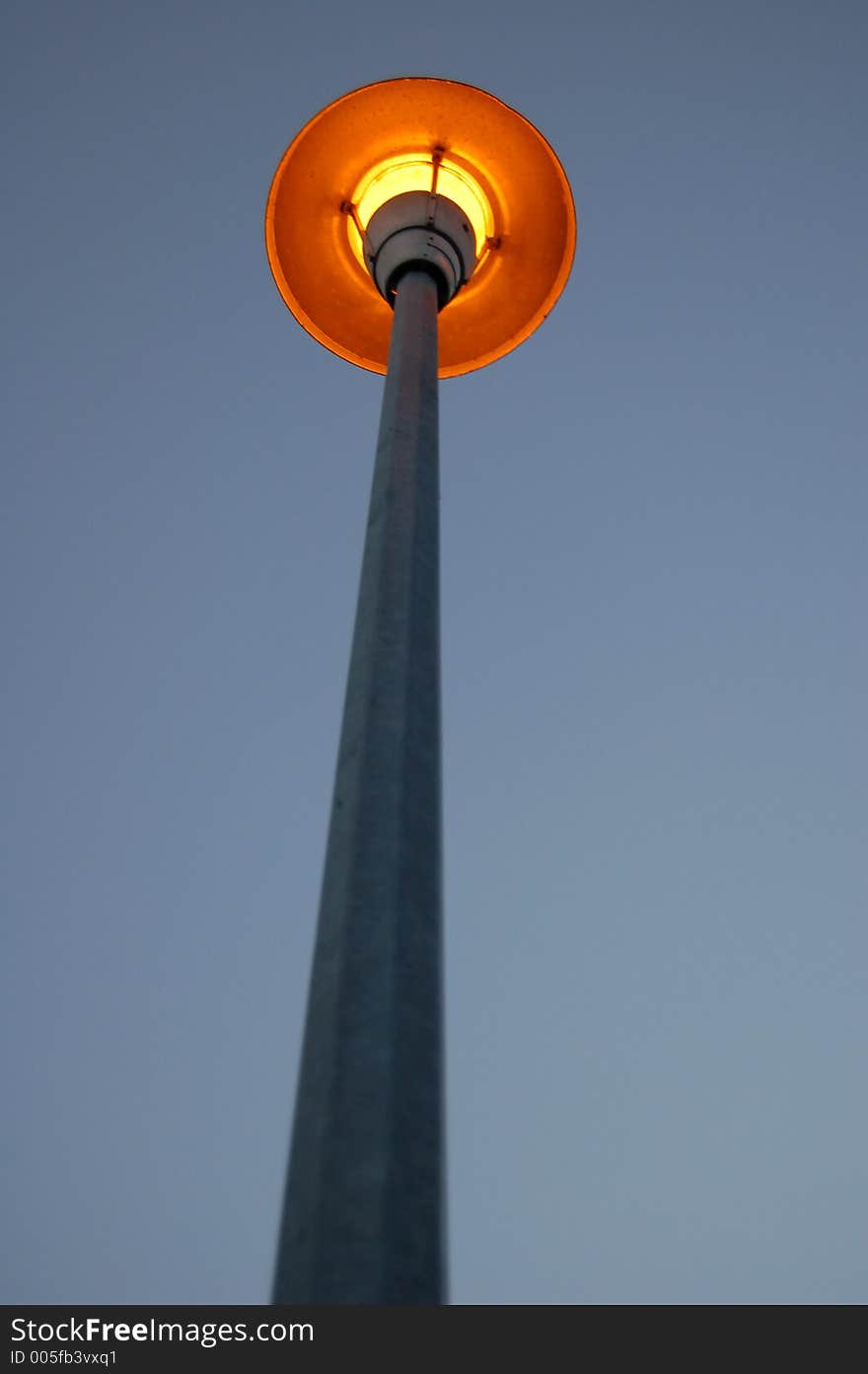 A lamp post/street light at dusk