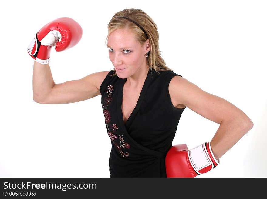 Attractive blonde executive business woman puts on the boxing gloves to do battle in the corporate world. Attractive blonde executive business woman puts on the boxing gloves to do battle in the corporate world.