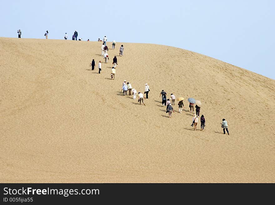 Japanese tourists climbing the sand dunes of Tottori. Japanese tourists climbing the sand dunes of Tottori.