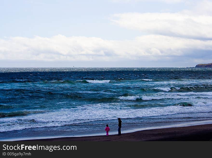 Mother and child bonding off coast at Takuboku Park overlooking Pacific Ocean in Japan Hokkaido.