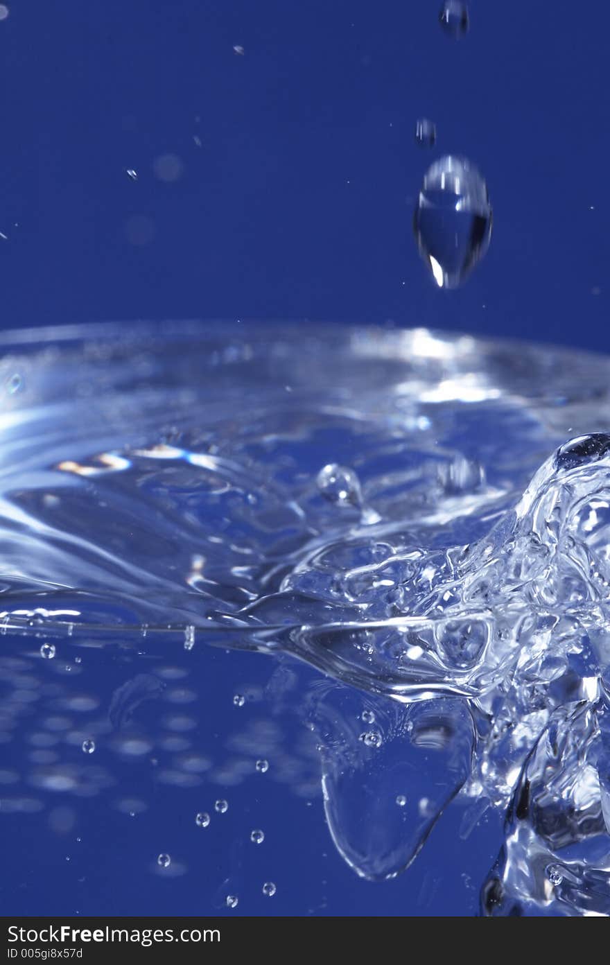 Sparkling water dropping in a glass with many bubbles. Sparkling water dropping in a glass with many bubbles