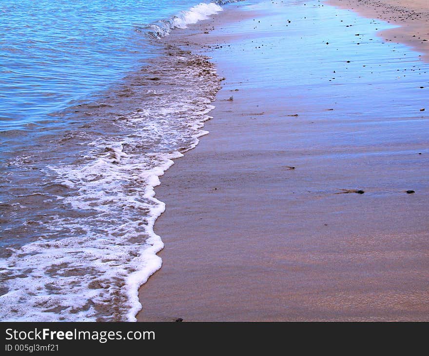 Reflected sky in the beach