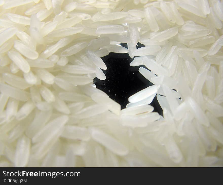 Picture of grains of rice on a mirror. rice is thailand or siamese. Picture of grains of rice on a mirror. rice is thailand or siamese