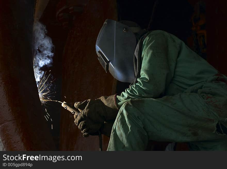 Welder working on ship. Welder working on ship