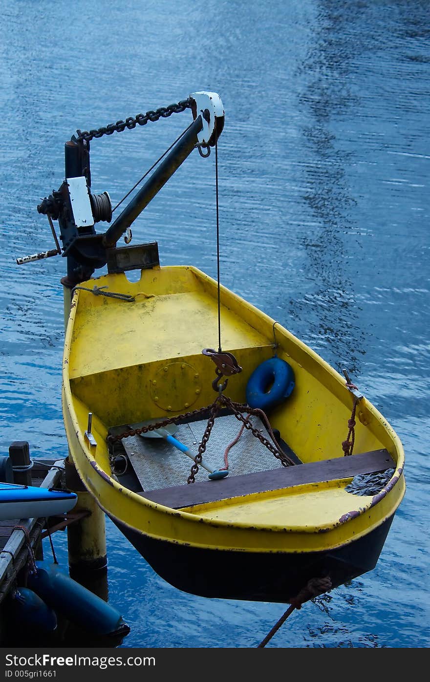 A small boat on a crane