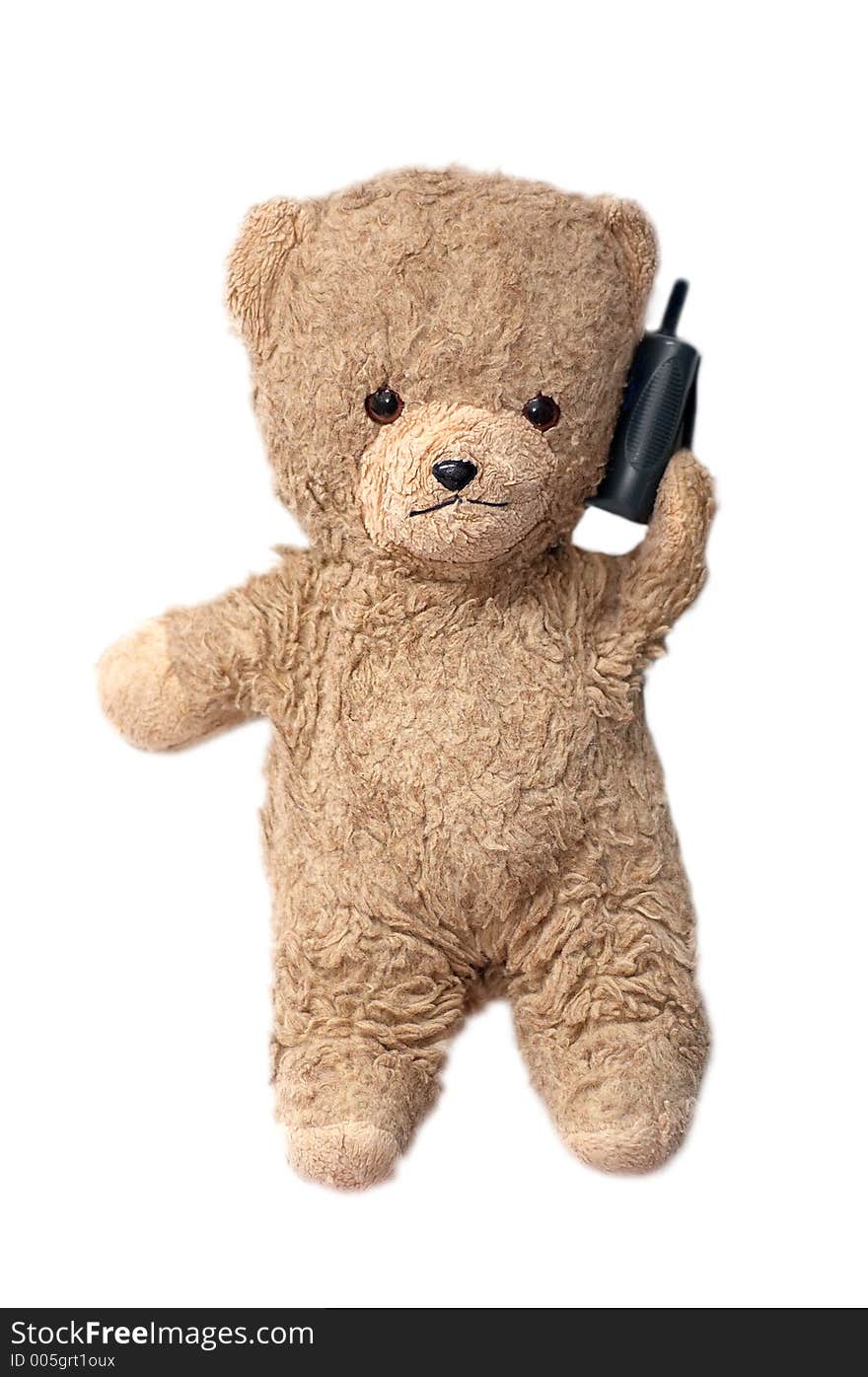 Photo of a teddybear holding a phone. Photo of a teddybear holding a phone