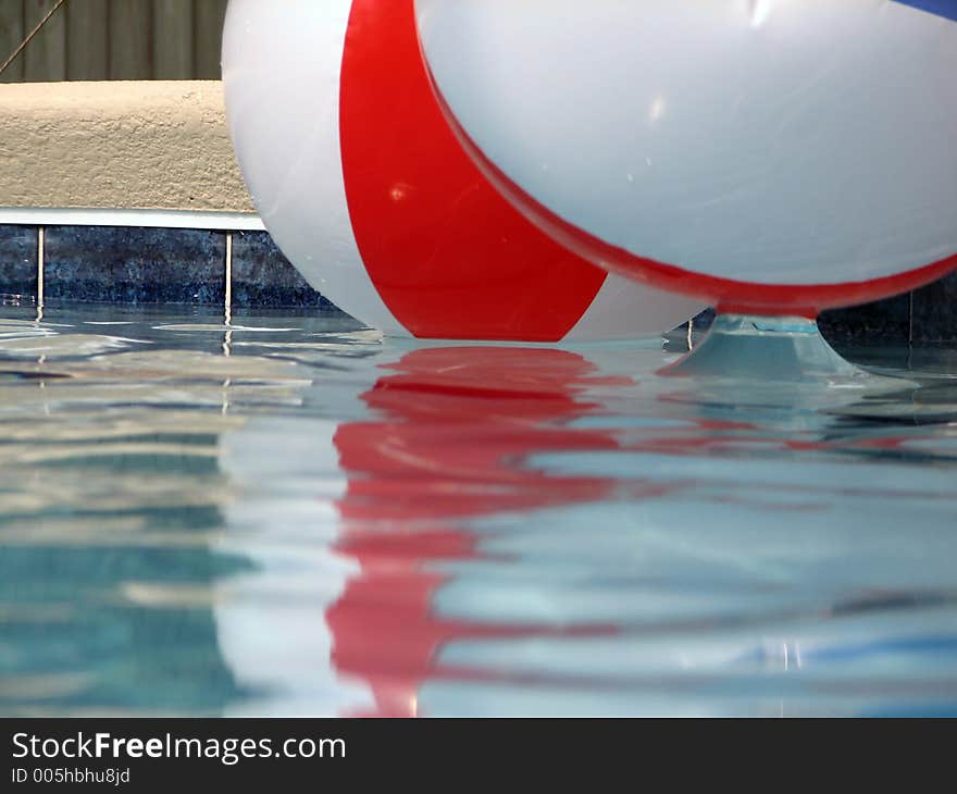 Shot of two beach balls in a pool. Shot of two beach balls in a pool.