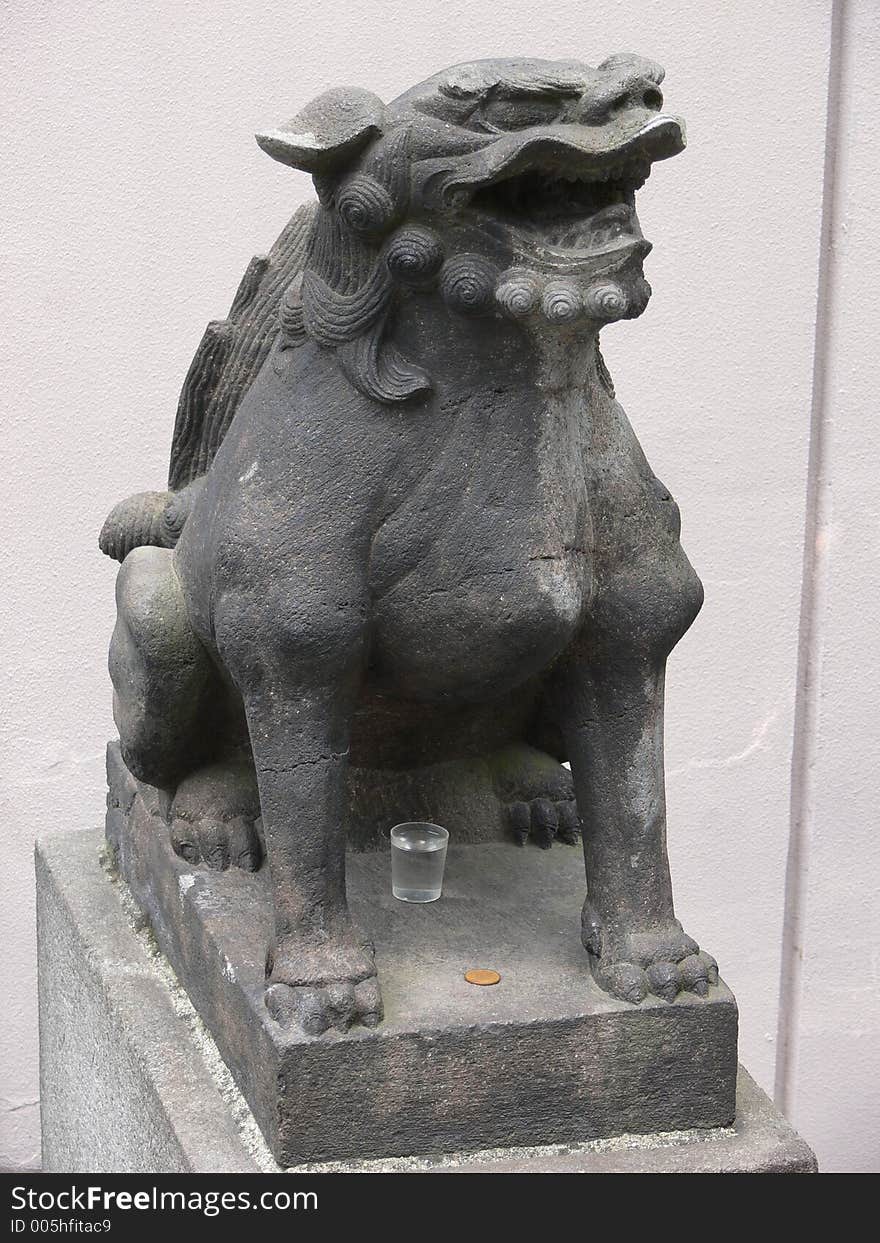 Figure of a fantasy dog at a japanese temple. Figure of a fantasy dog at a japanese temple