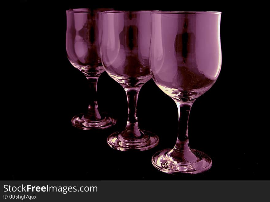 Pink wine glasses isolated on black background. Pink wine glasses isolated on black background