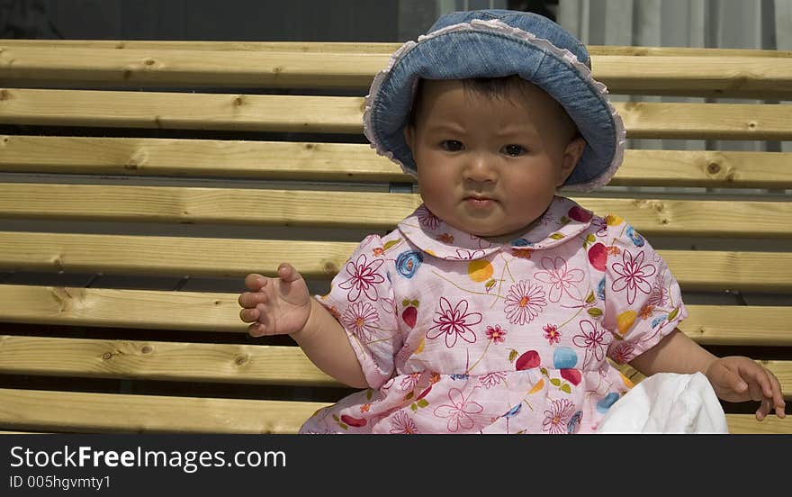 Cute baby girl sitting on a couch. Cute baby girl sitting on a couch