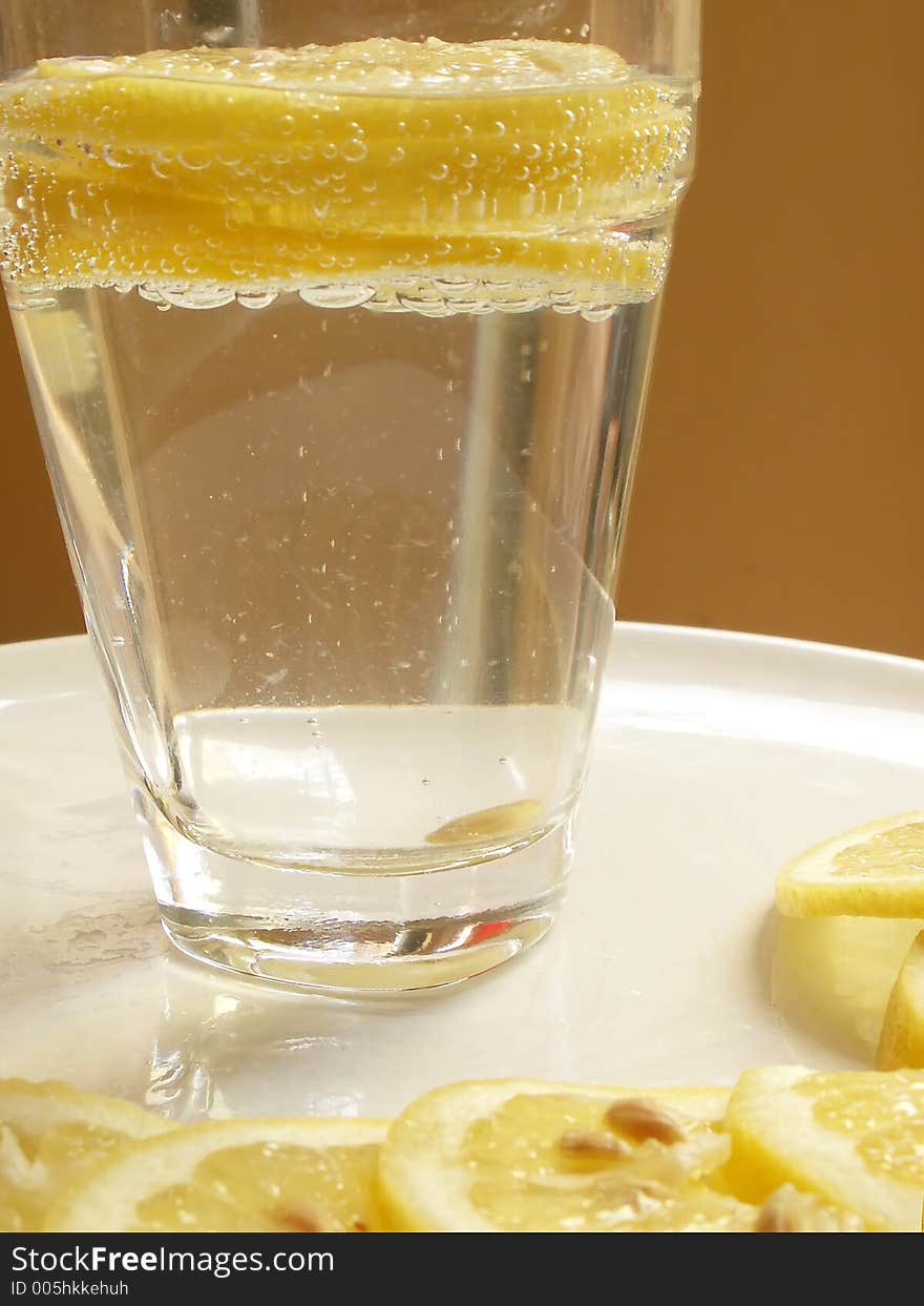 Lemon slices and glass of water. Lemon slices and glass of water