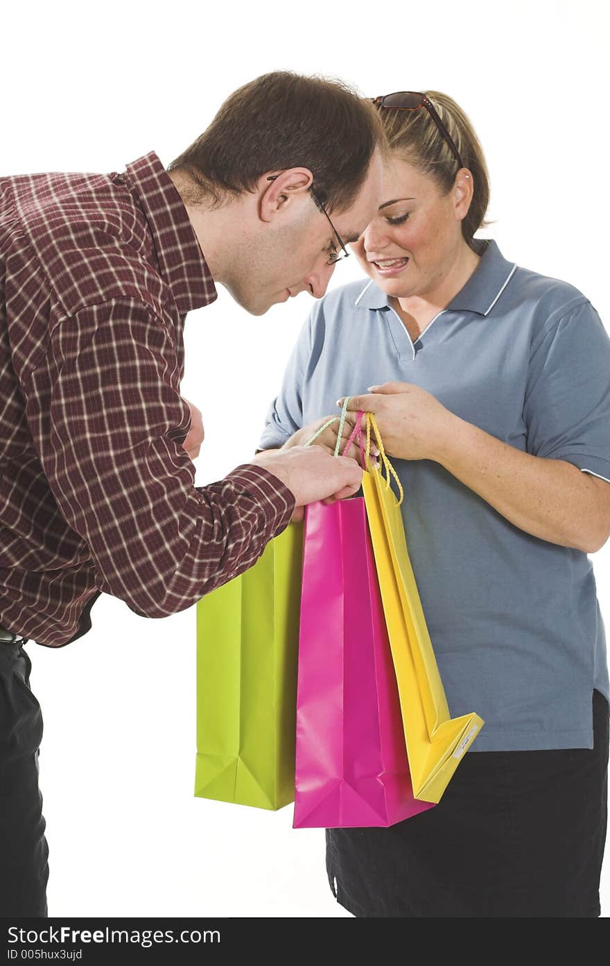 Couple with shopping bags over white background