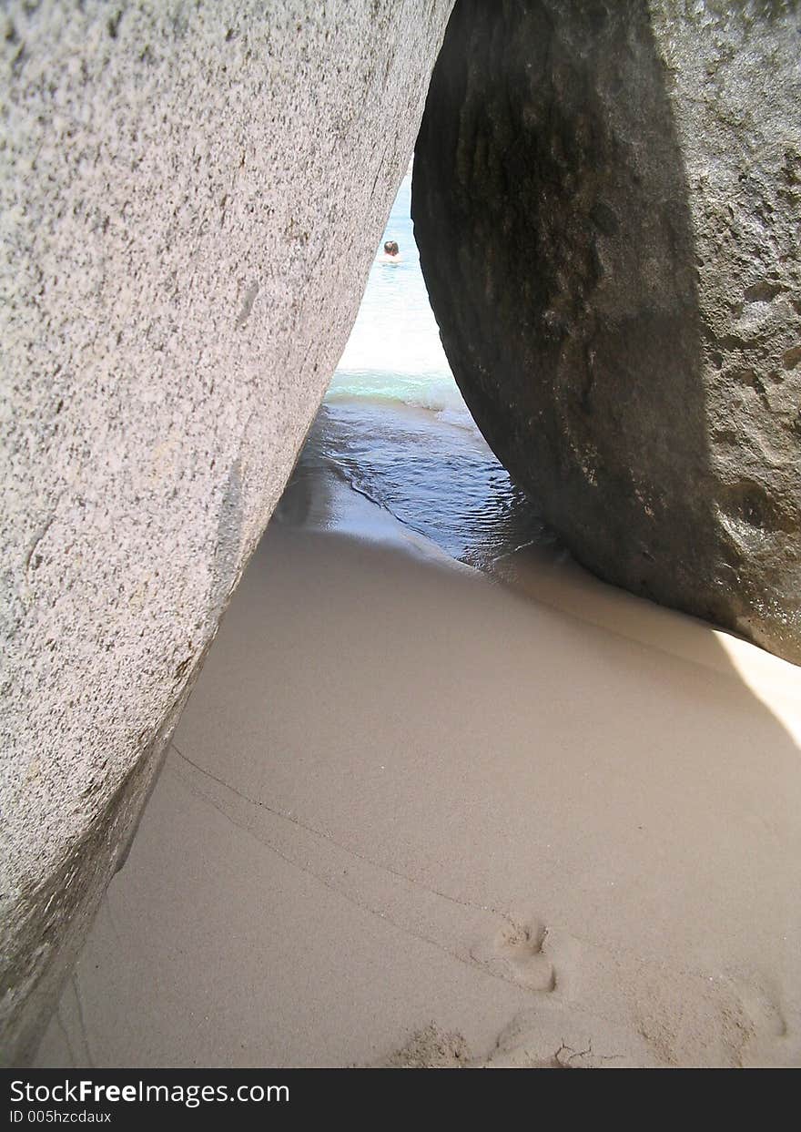 The immense boulders on the Beach at Virgin Gorda, British Virgin Islands, sit in ways that create small openings. 

If you can, please leave a comment about what you are going to use this image for. It'll help me for future uploads.