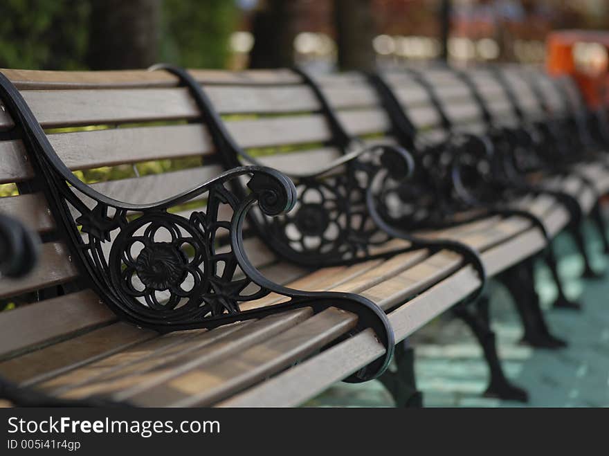 This row of bench was taken in an amusement park while resting. This row of bench was taken in an amusement park while resting.