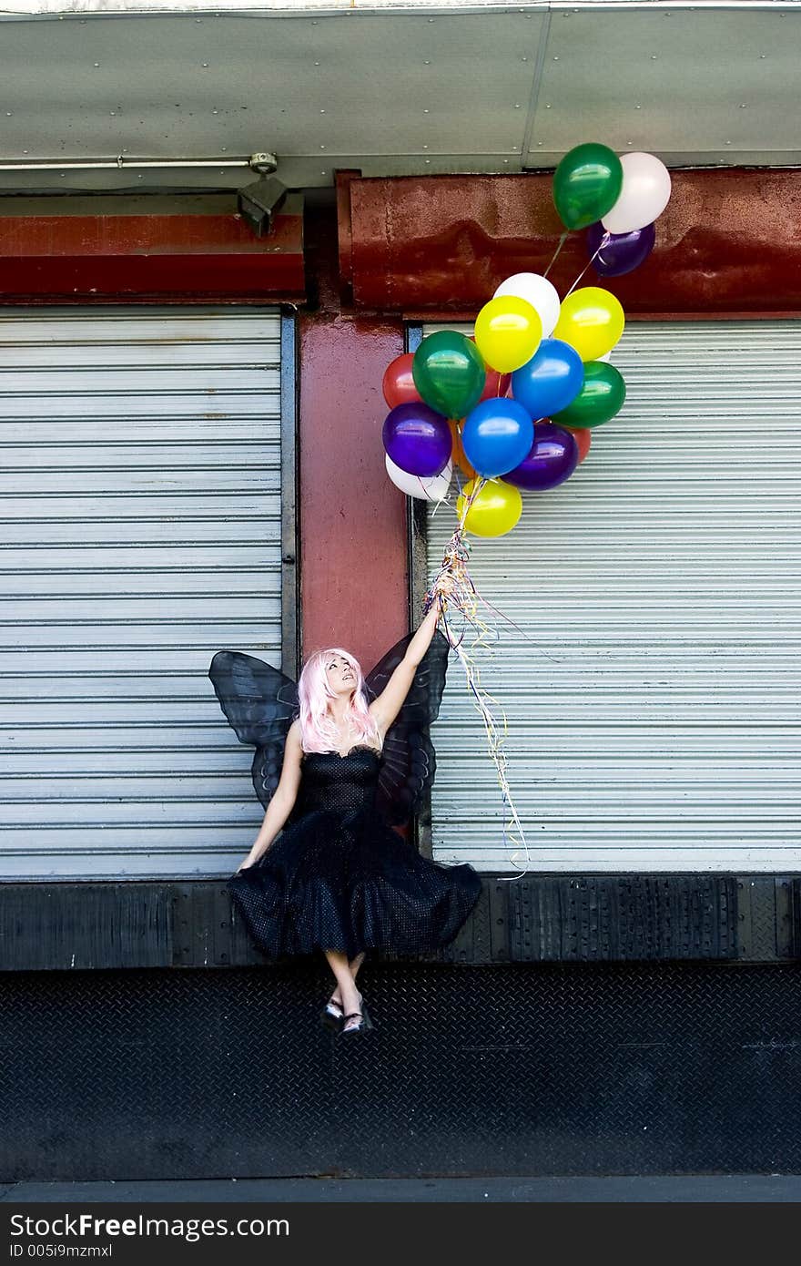 Fairy with balloons in an urban setting