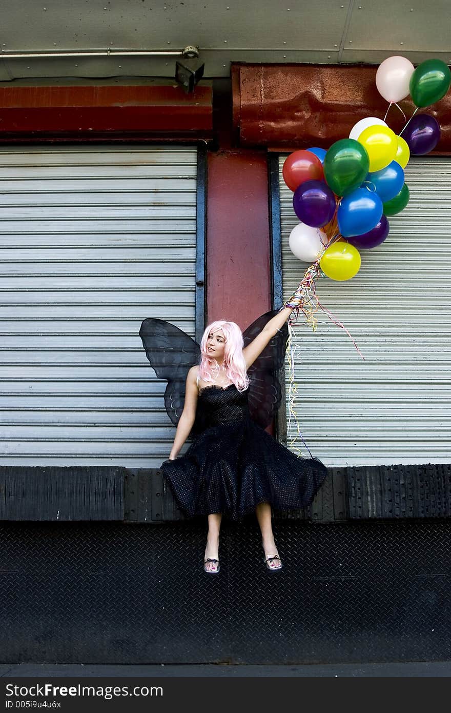 Fairy with balloons in an urban setting