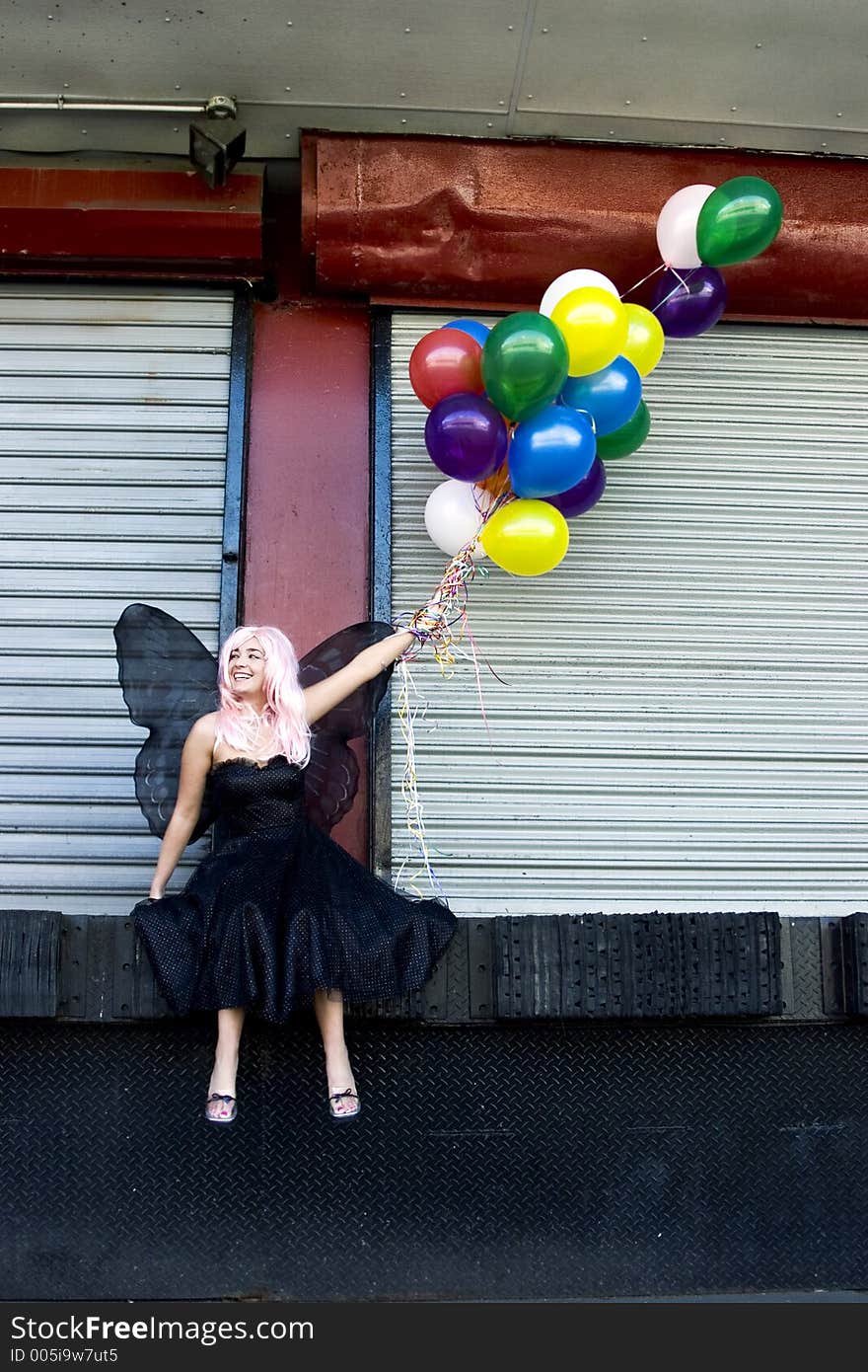 Fairy with balloons in an urban setting