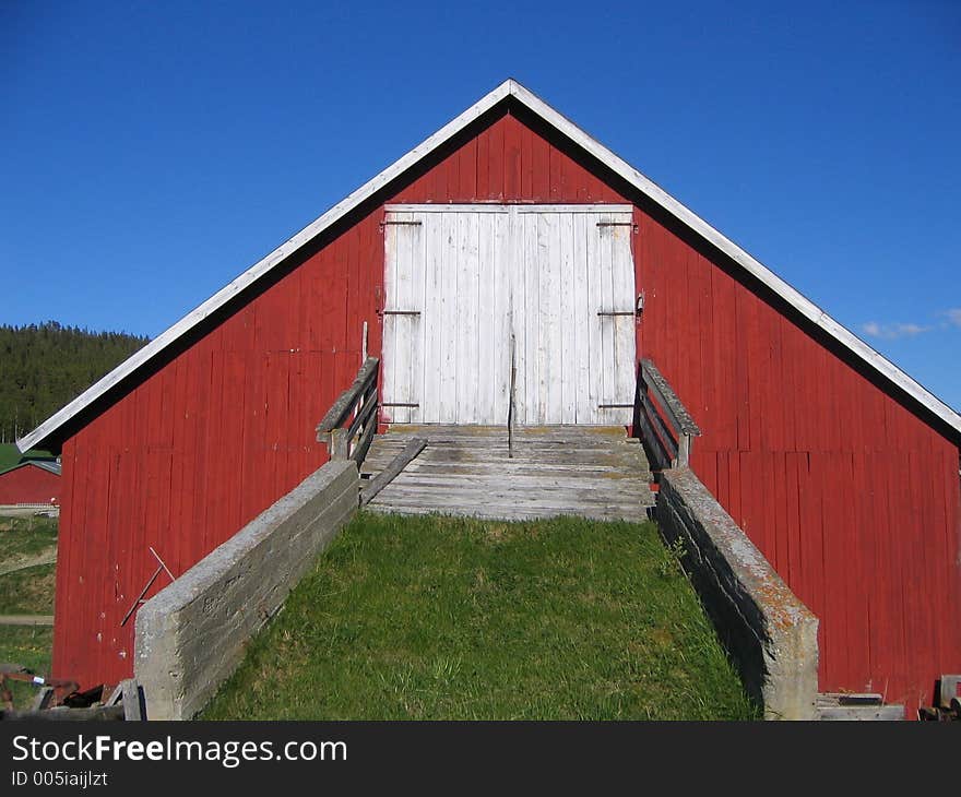 Norwegian dairy barn with bridge to drive in the hay. Norwegian dairy barn with bridge to drive in the hay