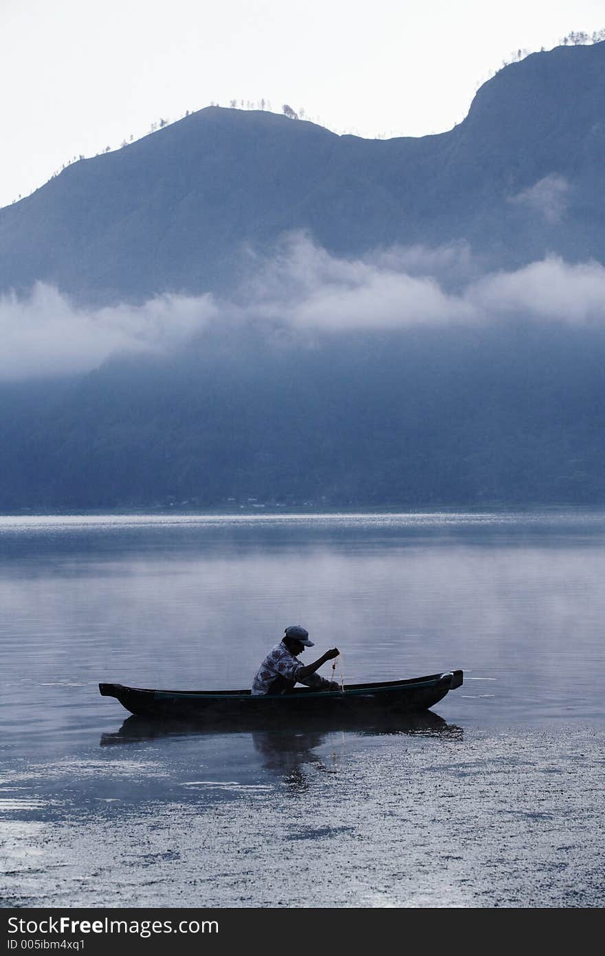 Fisherman working in a misty morning. Fisherman working in a misty morning