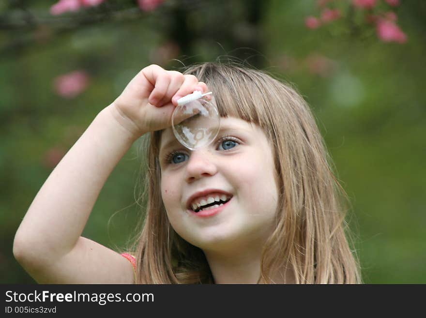 Series of girl blowing bubbles wiith wand - 5th. Series of girl blowing bubbles wiith wand - 5th