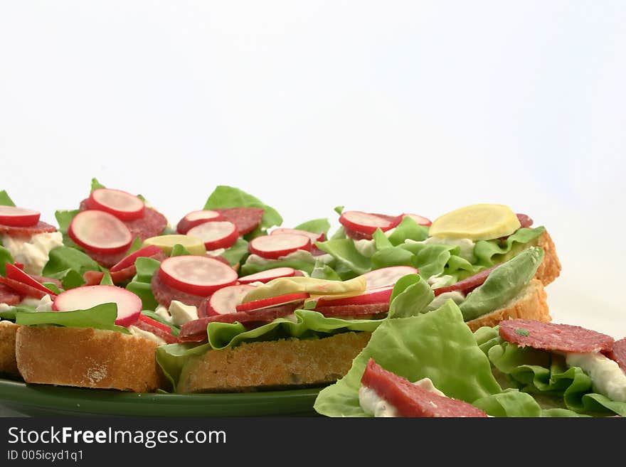 Close view at fresh sandwiches put on plate. Close view at fresh sandwiches put on plate