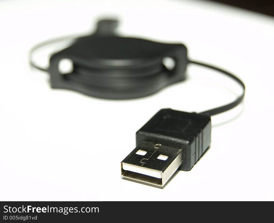 Black USB Cable over white background Shallow Depth of field