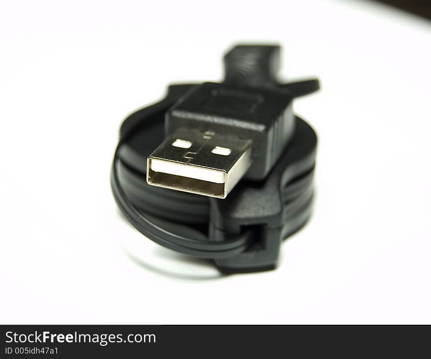 Black USB Cable over white background Shallow Depth of field