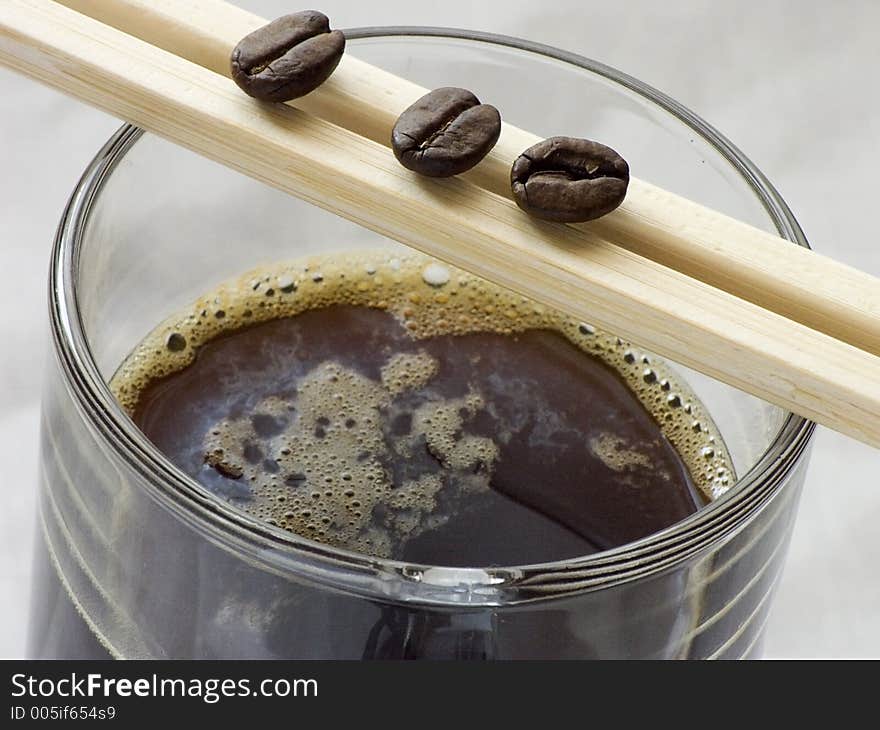 Glass of coffee and chopsticks. Glass of coffee and chopsticks